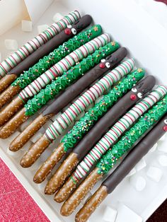 a box filled with chocolate covered pretzels and candy canes on top of each other