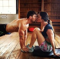 an image of a man and woman kissing on the floor