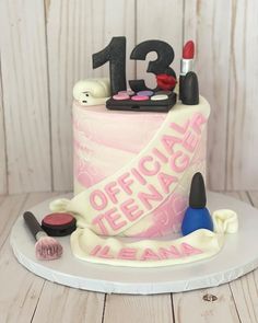 a birthday cake decorated with makeup and lipstick