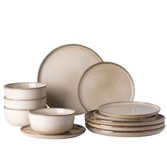 a set of white dishes with gold rims