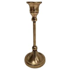 a brass colored candle holder on a white background