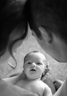 a woman holding a baby in her arms