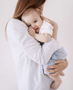 a woman holding a baby in her arms