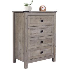 a wooden dresser with four drawers and a clock on it's top, against a white background