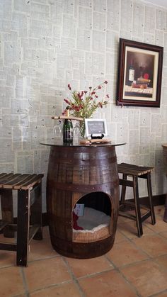 a wine barrel table and stools in a room with white brick wall paper on the walls