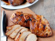 sliced chicken and slices of meat on a cutting board