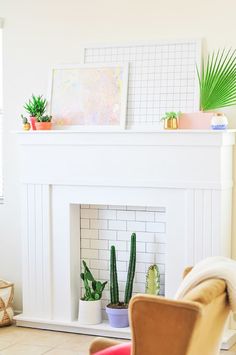 a living room filled with furniture and a fire place covered in potted plants next to a white fireplace