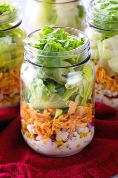 several mason jars filled with different types of salads