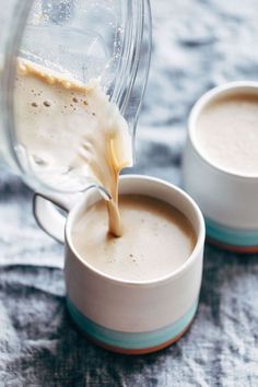 two cups filled with liquid sitting on top of a table