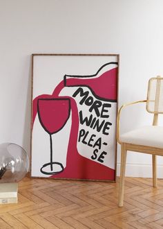 there is a wine glass on the floor next to a chair and a sign that says more wine please