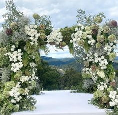 an arch made out of flowers and greenery