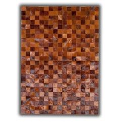 a brown area rug with squares on the top and bottom in different shades of brown