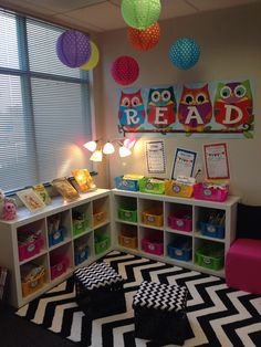 the room is decorated with bright colors and lots of bookshelves for children to read