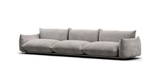 a gray couch with four pillows on it's back and one arm facing the camera