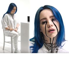 a woman with blue hair is sitting on a chair and has her face painted black