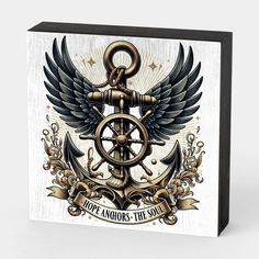 an anchor and wheel with wings on a white wooden plaque that says hope anchors the soul