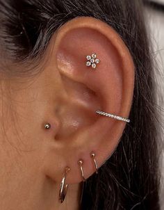 a woman with three piercings on her ear