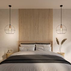 a bed with two lamps hanging above it next to a wall that has wood paneling