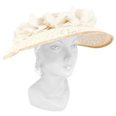 1950s cream-colored starched lace picture hat with handmade french silk flowers, velvet trim, and bow accent. This hat is meant to be worn with a hat pin to secure it to the head. Luxury Vintage Cream Hat, Vintage Cream Fascinator For Royal Ascot, Cream Vintage Fascinator For Royal Ascot, Cream Costume Hats And Headpieces For Church, Cream Mini Hats For Vintage Events, Cream Brimmed Cloche Hat For Evening, Adjustable Cream Hat For Evening, Vintage Cream Headpieces For Vintage Events, Vintage Cream Fascinator For Evening