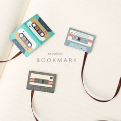 a bookmark with tape and cassettes attached to it