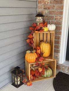 three wooden crates with pumpkins and gourds stacked on top of each other