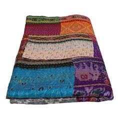 a multicolored blanket is folded on top of each other