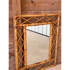 a mirror that is on top of a wooden table next to a wall and floor