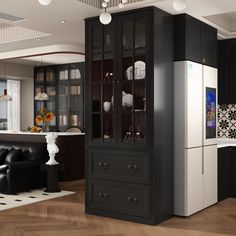 a black and white kitchen with lots of cabinet space in the center, along with a dining room table