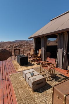 an outdoor area with chairs, tables and luggage