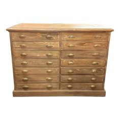 a wooden dresser with many drawers and knobs on the bottom drawer, against a white background