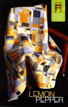 a quilted blanket sitting on top of a wooden chair