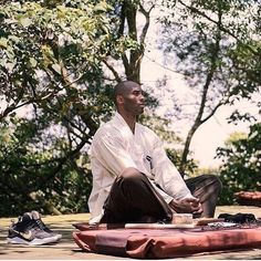 a man sitting on the ground with his feet crossed