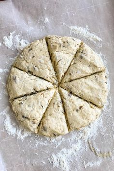 an uncooked pizza sitting on top of a table covered in floured dough