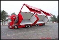 a red semi truck with an unusual design on the front and side doors that are open