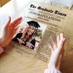 a person is holding up a fake graduation card