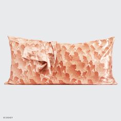 an orange pillow with a bow on it