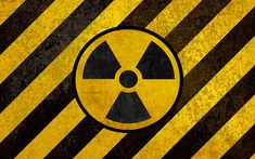 a yellow and black hazard sign with the symbol of radiation on it's side