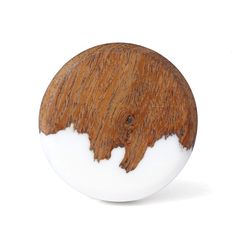 a wooden object with white paint on the top and brown wood in the middle, against a white background