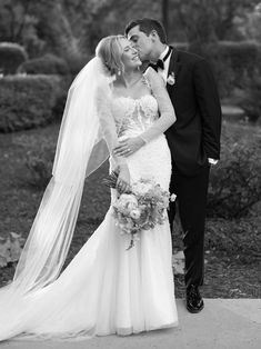 a bride and groom kissing on their wedding day