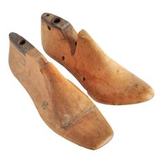 two old wooden shoes with holes in them