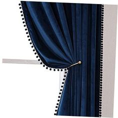 a blue curtain with pom poms hanging from it