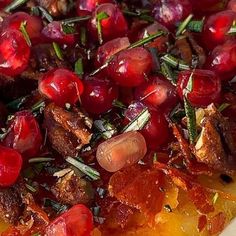 a close up of a pizza with cherries on it