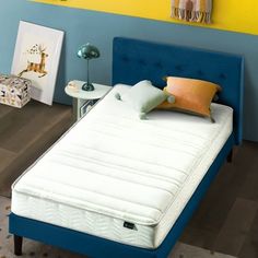 a bed with blue headboard and yellow pillows in a child's playroom