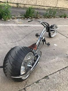 a person standing next to a parked motorcycle on the street with it's front tire missing