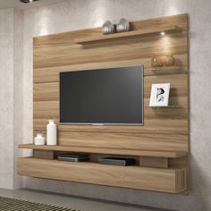 a tv is mounted on a wooden wall