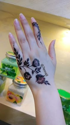 a woman's hand with a tattoo on it