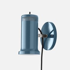 a blue wall light with a black cord attached to the arm and an electric outlet plugged into it