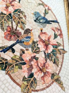 a mosaic table with flowers and birds on it