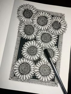 a black and white drawing of sunflowers with a pencil in the foreground