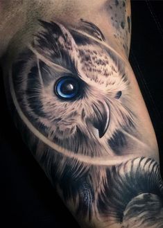 an owl with blue eyes is shown on the left arm and leg, while it's also visible in the upper half